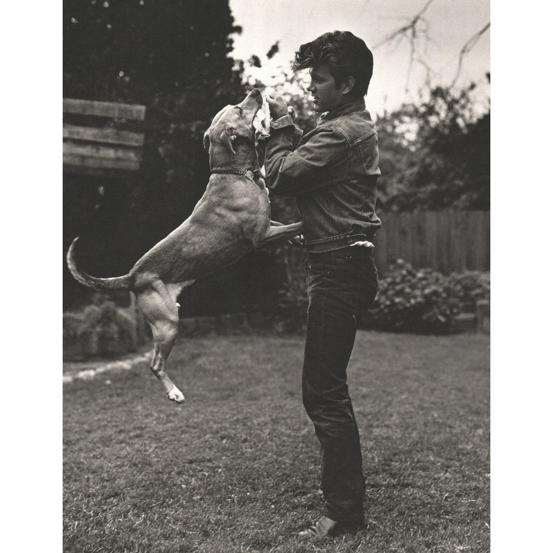 BRUCE WEBER - Chris Isaak and his Dog, 1986: Artist: BRUCE WEBER Print Title: Chris Isaak and his Dog, 1986 Medium: Sheet-fed Gravure Printing Date: 1980's Printed in Spain Image Size approx: 11 X 8.5 inches Bruce Weber is an American fashion ph