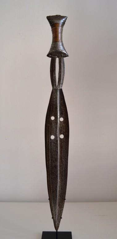 Boa knife: Title: Boa Knife Date/Period: XXth century Materials: Iron, copper, wood Dimension: 18" 1/8 Description: This is a prestige weapon for Boa chiefs of Province Orientale in D.R. Congo. On a custom base.