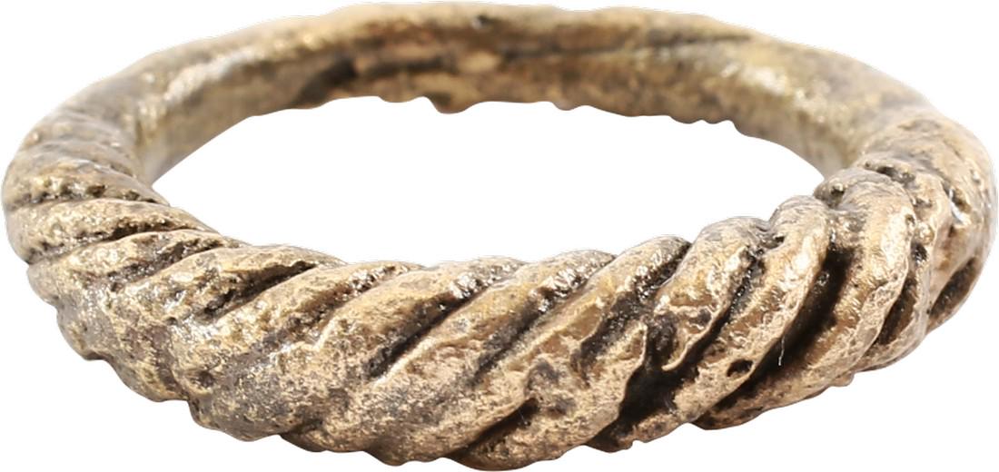 VIKING ROPED OR TWIST WEDDING RING: Cambridgeshire, England, 866-1067 AD Oval form, size 7 ½-7 ¾. 3.2mm at the bottom swelling to 5.1mm at the top. The top half in deeply modeled roped motif. The spiral or helix was a favorite Viking 