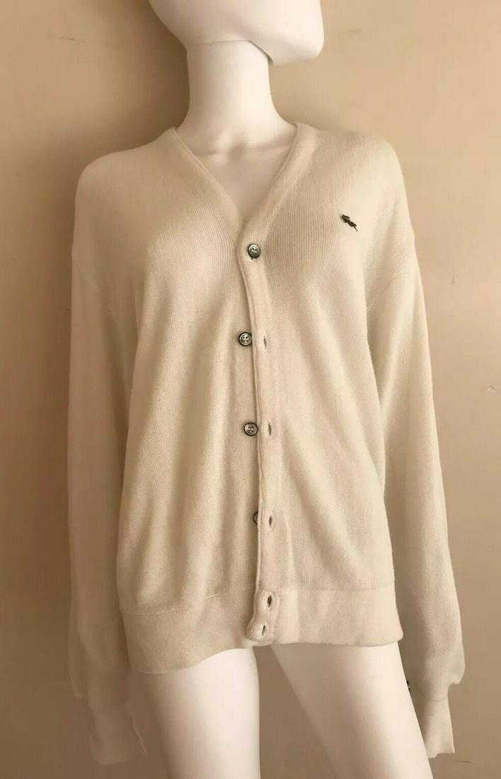 Lacoste Off White Cardigan Size Large: DK Lacoste Off White Cardigan Size LargeWonderful cardigan that is a necessity in your collection.The fit is lovely.This is made of acrylic. The chest measurement is 22.5 inches. The top to bottom mea