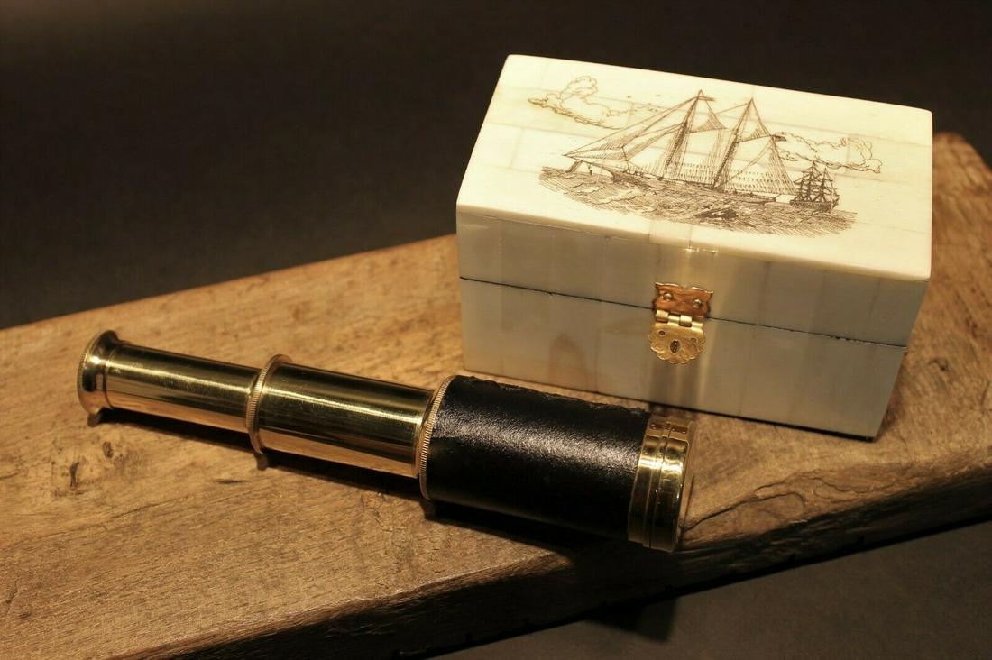 Sailboat Bone & Wood Scrimshaw Box w Telescope: Box measures 4 3/4" Long x 2 5/8 wide x 2 5/8" tall Telescope measures 3 3/8" Long closed x 6 1/4" open Nice quality reproduction of a traveling pocket telescope and cap. This piece is all brass wrapp