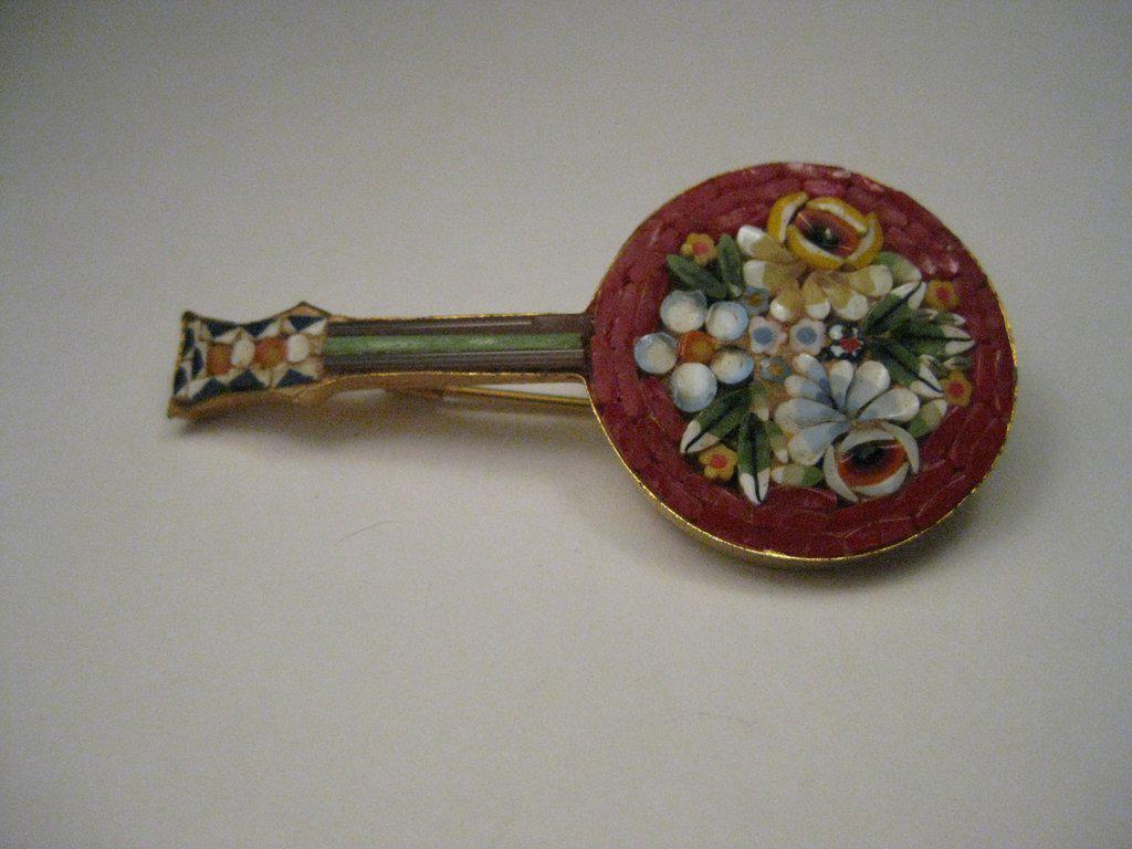 Vintage Micro Mosaic Banjo or Guitar Brooch, Gold Tone,: Vintage Micro Mosaic Banjo-shaped instrument Brooch, gold tone with a floral theme - beautiful detailed mosaic of yellow and blue f lowers with green and white leaves and a red framed border with a br