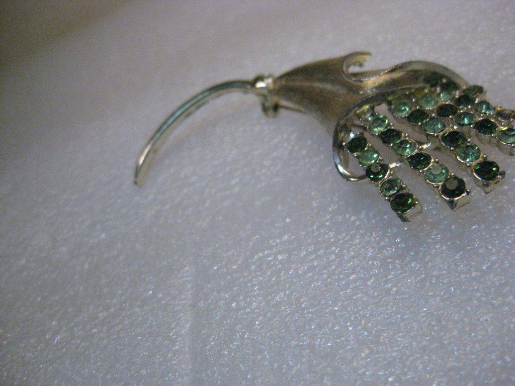 Vintage Silver Tone Coro Pegasus Brooch Shades of Green: Vintage Coro Pegasus Silver Tone Green Rhinestone Floral Brooch. This is 3.25" long and 1.5" wide - it is a long textured silver tone brooch - with a wrapped blossom from which rays of shades of green