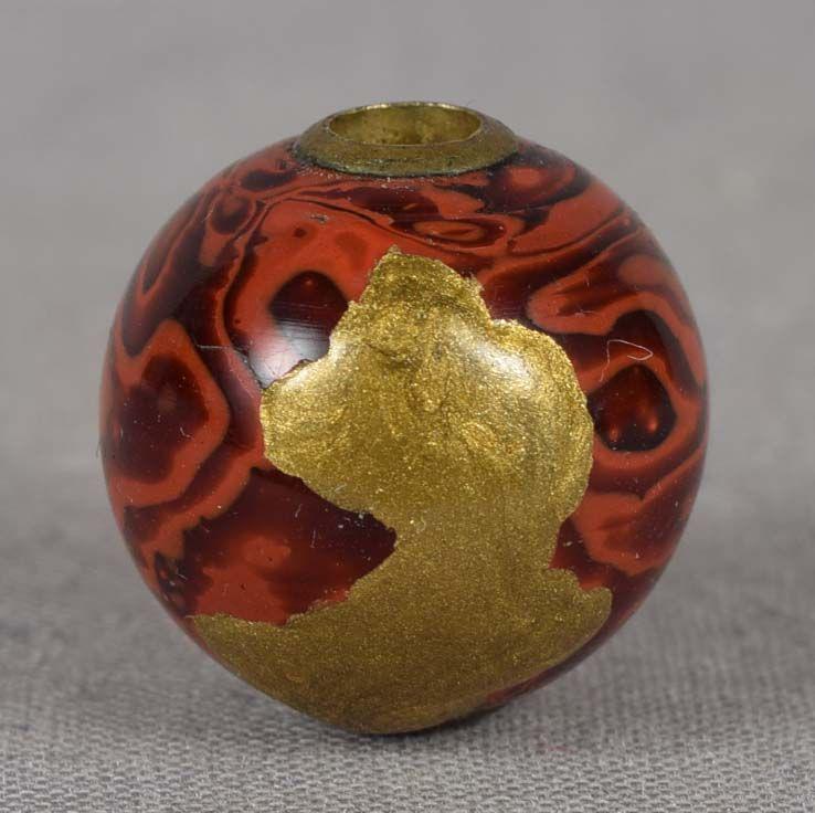 19c OJIME netsuke slide Japanese lacquer: 19th century lacquer ojime (slide bead for tightening the cord going from netsuke to inro) in ball shape with marbled black and red surface and golden lacquer patch. Wonderful work, strong design, met