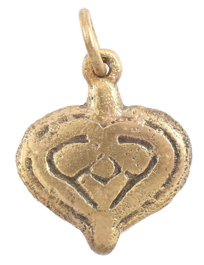 FINE VIKING HEART NECKLACE PENDANT 900-1050 AD JEWELRY: 5/8” width, domed with a broad double border and central trefoil motif. The inner borders scrolling to cross and form the cusp of the heart and the top of the trefoil. The foliate trefoil was a very