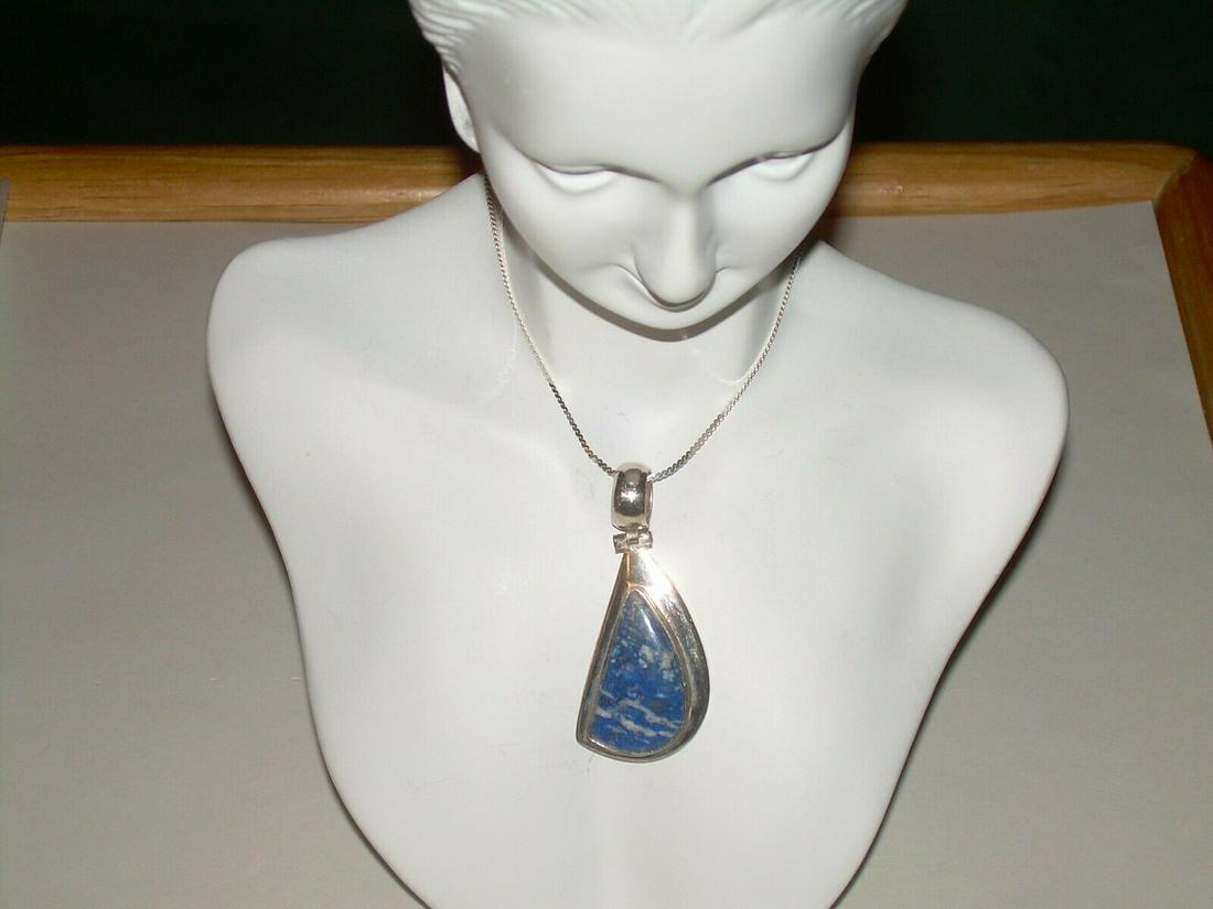 Sterling Southwestern Blue Sodalite Necklace/Penda; nt,: Vintage sterling silver southwestern blue sodalite necklace/pendant has a raised bezel set stone in the center. The stone is 24.6mm long and 13.8mm at its widest point. The pendant is marked 950 and C