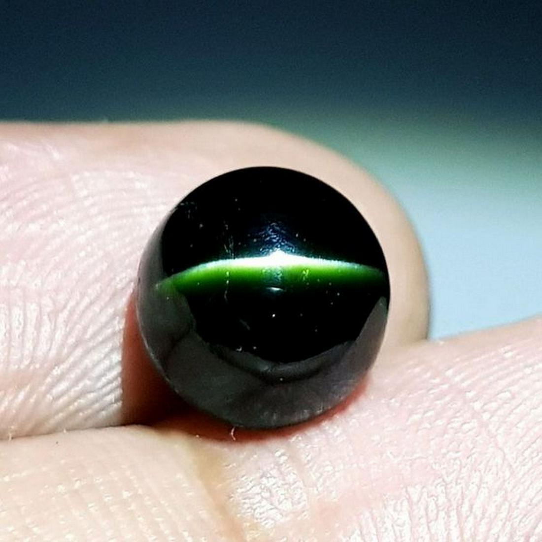 Natural Kornerupine Cat's Eye 5.45 ct: No Reserve! Title: Natural Scapolite Cat's Eye 5.45 ct Color/Clarity: Opaque Gemstones: Loosegemstone Carat Weights: 5.45 Size/Dimensions: 9.00 x 8.00 x 7.90 Additional Information: Round - Srilanka S