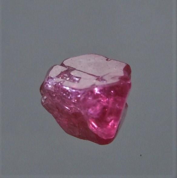 1.5 CT TRANSLUCENT RUBY - UNTREATED GEMSTONE: Title: 1.5 CT TRANSLUCENT RUBY - UNTREATED GEMSTONE Origin: Mogok Township, Mandalay Region, Myanmar Size: 0.55x0.5x0.5 cm / 0.3 gram Description: translucent, pyramidal ruby crystal with trigons and 