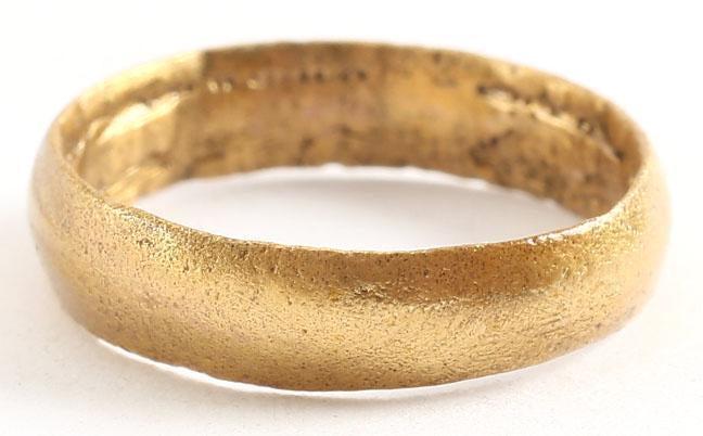 VIKING WEDDING RING SZ4: Late 9th-early 11th century AD. Gilt bronze, size 4. Medium width band 3.8mm, with a rounded face. The inside with distinct tool marks from a removal of the central core after casting. Professionally 