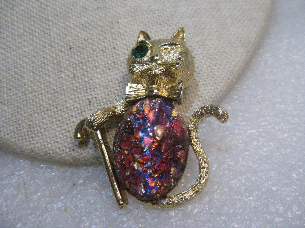 Vintage Confetti Belly Cat Brooch, w/ Cane, Winking,: Vintage Confetti Belly Cat Brooch, Winking with one green eye and a cane - curled tail. 2" long and 1.5" wide. The confetti stone is oval filled with foiled confetti in oranges/red/blue/pinks/and gold
