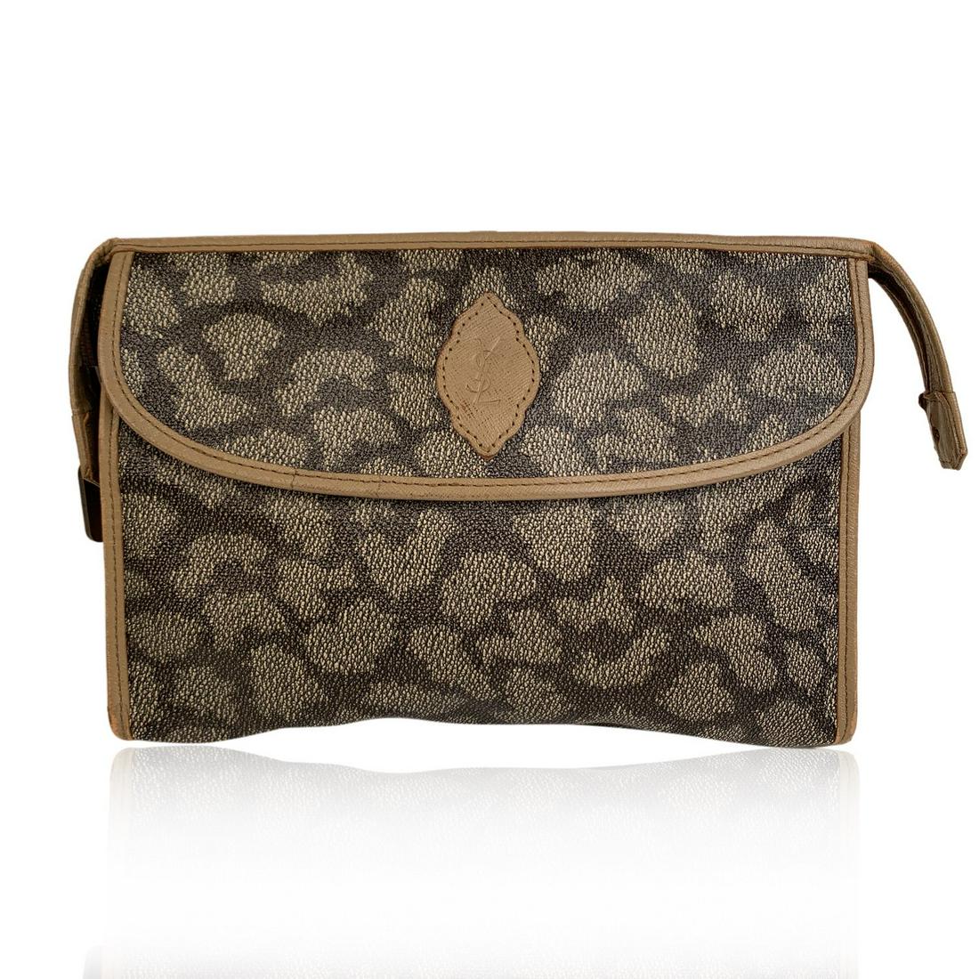 Yves Saint Laurent Vintage Tan Spotted Canvas Cosmetic: Yves Saint Laurent Vintage Canvas & Leather Clutch from the 1980s. Crafted in gray giraffe spotted print canvas with tan leather trim. YSL logo patch on the front. Front pocket with flap and magnetic 