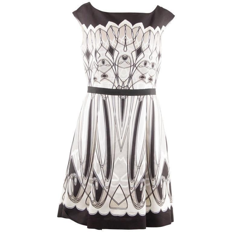 Blumarine Black White Beige Art Deco Print Fit & Flare: Blumarine Black White Beige Art Deco Print Fit & Flare Dress. Fit and flare dress from Blumarine. Featuring graphic print in black beige and white tones inspired by the art deco movement. Boat necklin