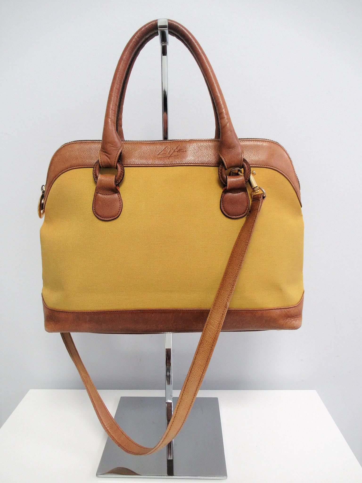 "Givenchy Life" canvas and leather bag: Canvas and leather bag from “Givenchy Life”.Crafted in mustard yellow canvas and hazelnut leather.Logo printed on the front.Removable shoulder strap.Gold colored hardware.It is a practical but ver