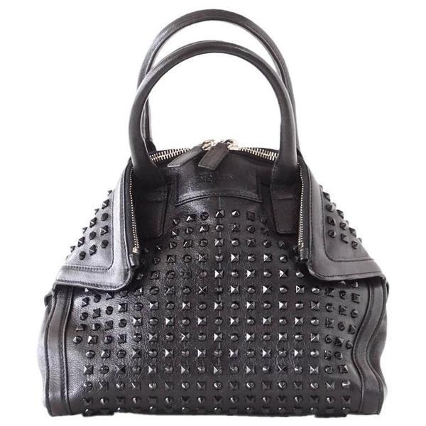 Alexander McQueen Bag Black on Black De Manta Tote: Guaranteed authentic Alexander McQueen black De Manta tote bag. Chic black on black studded bag with double top zip. Bag edges fold over hidden magnetic tabs. Detachable shoulder straps add versatilit