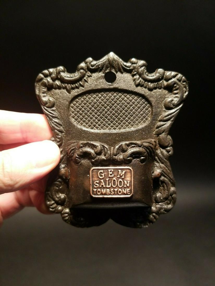 Cast Iron Match Holder: 4" x 3 1/4" Such a neat reproduction antique cast iron saloon match holder. As you can see the front of the intricate match holder says "Gem Saloon Tombstone" Reserve: $15.00 Shipping: Domestic: Flat-