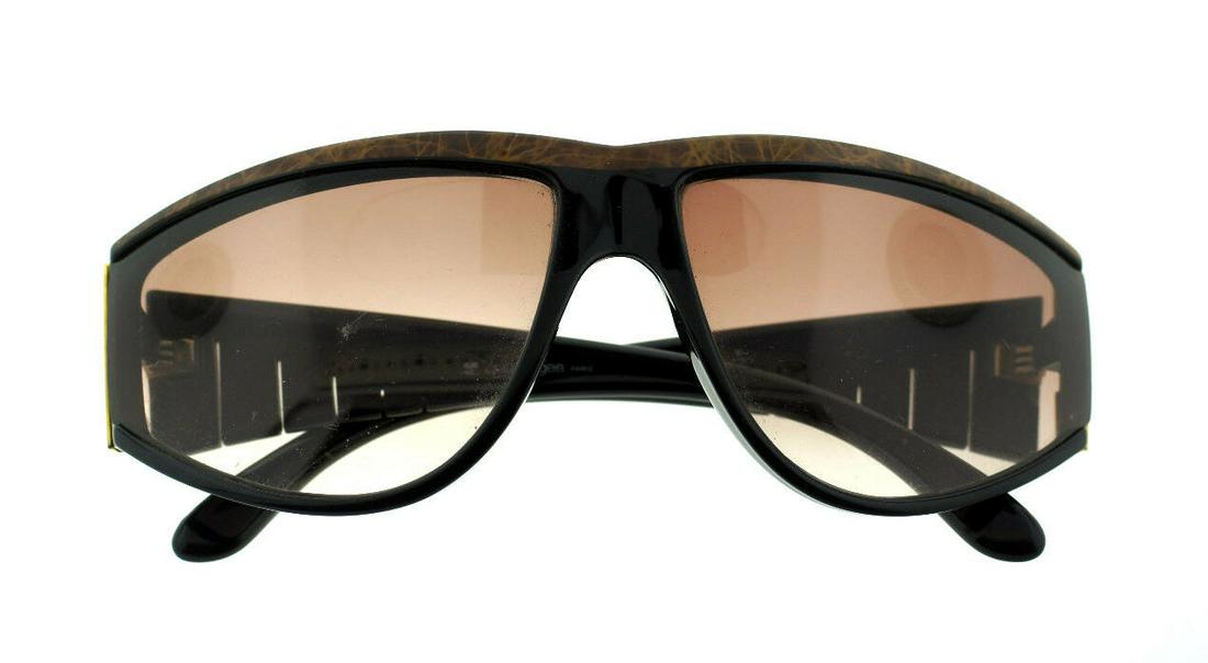 COURREGES MADE IN FRANCE SUNGLASSES PARIS BROWN GLASSES: N COURREGES AUTHENTIC SIGNED SUNGLASSES TRENDY & STYLISH These amazing sunglasses will look absolutely stunning with any outfit. The stylish plastic frame is BROWN WITH BLACK LINES. The sunglasses are