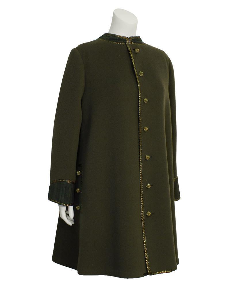 Geoffery Beene Green Coat with Gold Trim: 1960's Geoffrey Beene military inspired swing coat. Military green wool with gold tambour stitching throughout the trim, pockets and woven buttons. Cuffs and upper back have green polka dot ribbed det