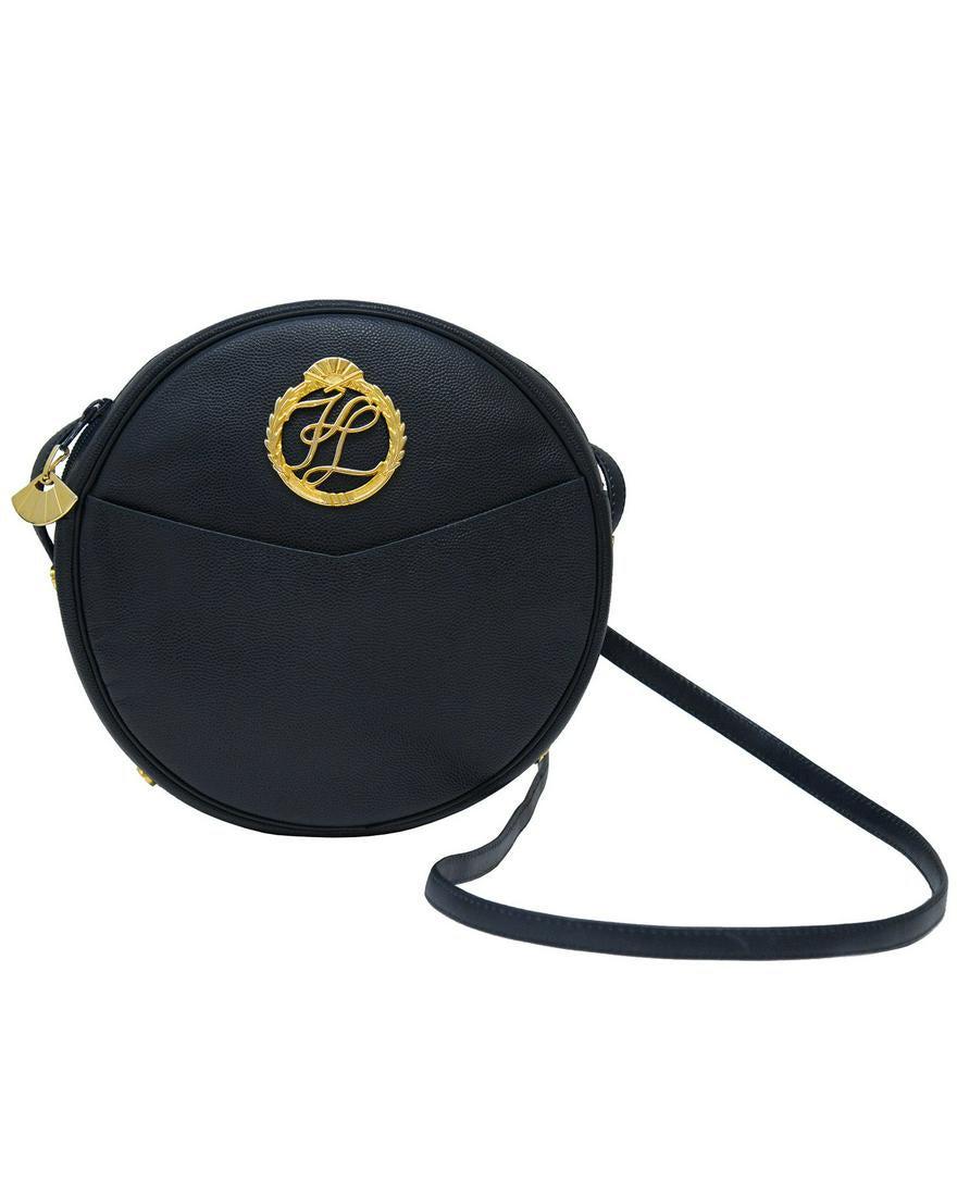 Karl Lagerfeld Blue Leather Round Crossbody Bag: Midnight blue pebbled leather round crossbody bag by Karl Lagerfeld from the 1980's. Zip top closure goldtone fan shaped pull tab, goldtone logo hardware affixed to the front of the bag above a single