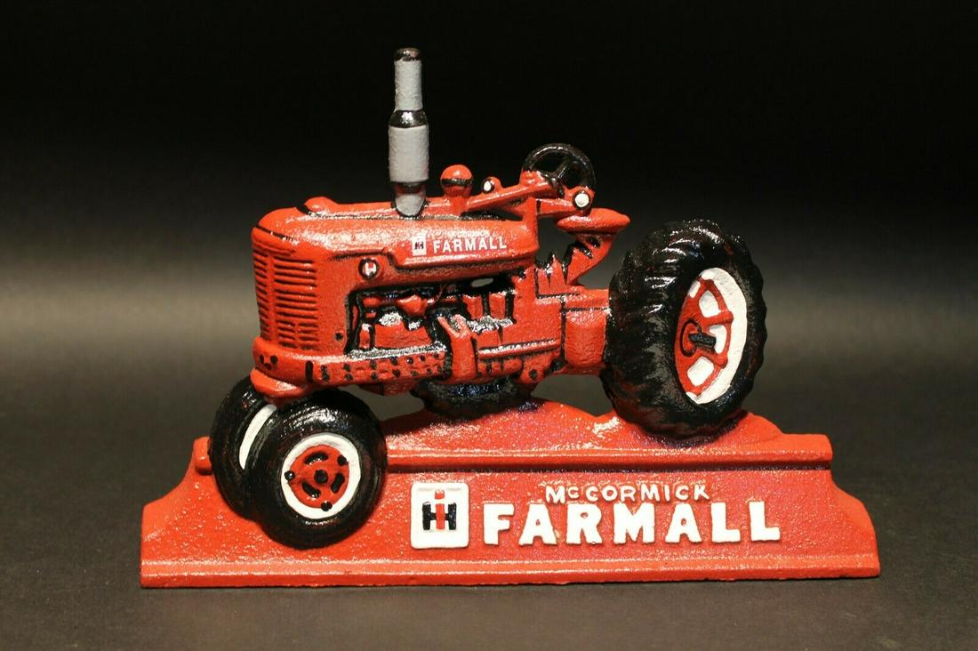 Cast Iron McCormick Farmall Tractor Door Stop: 9 1/8" Long x 6 1/8" tall 1 1/8" thick Nice Reproduction antique solid cast iron McCormick Farmall door stop. This door stop is much solid made nice and heavy with great detail as you can see in the p