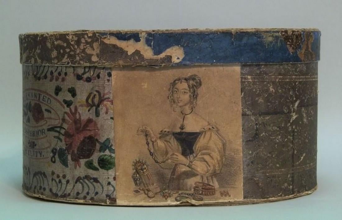Wallpaper Covered Bonnet Box: Date/Period: c/ 1840’s Origin: America Dimension: Overall Size is length: 11 1/2", Width: 9 1/2", Height: 6"Â· Provenance: Silver wallpaper with colored floral print on one side, black and brown f