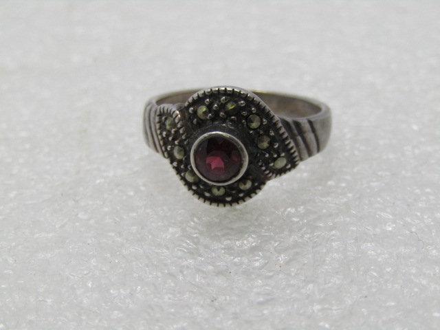 Vintage Sterling Tourmaline Marcasite Ring, size 7,: Vintage Sterling Tourmaline Marcasite Ring. 1970's. Size 7, 3.73 grams. The stone tests as red tourmaline . It is 4mm and bezel set and raised from the base by appx. 3.5mm. It has a bypass base that h