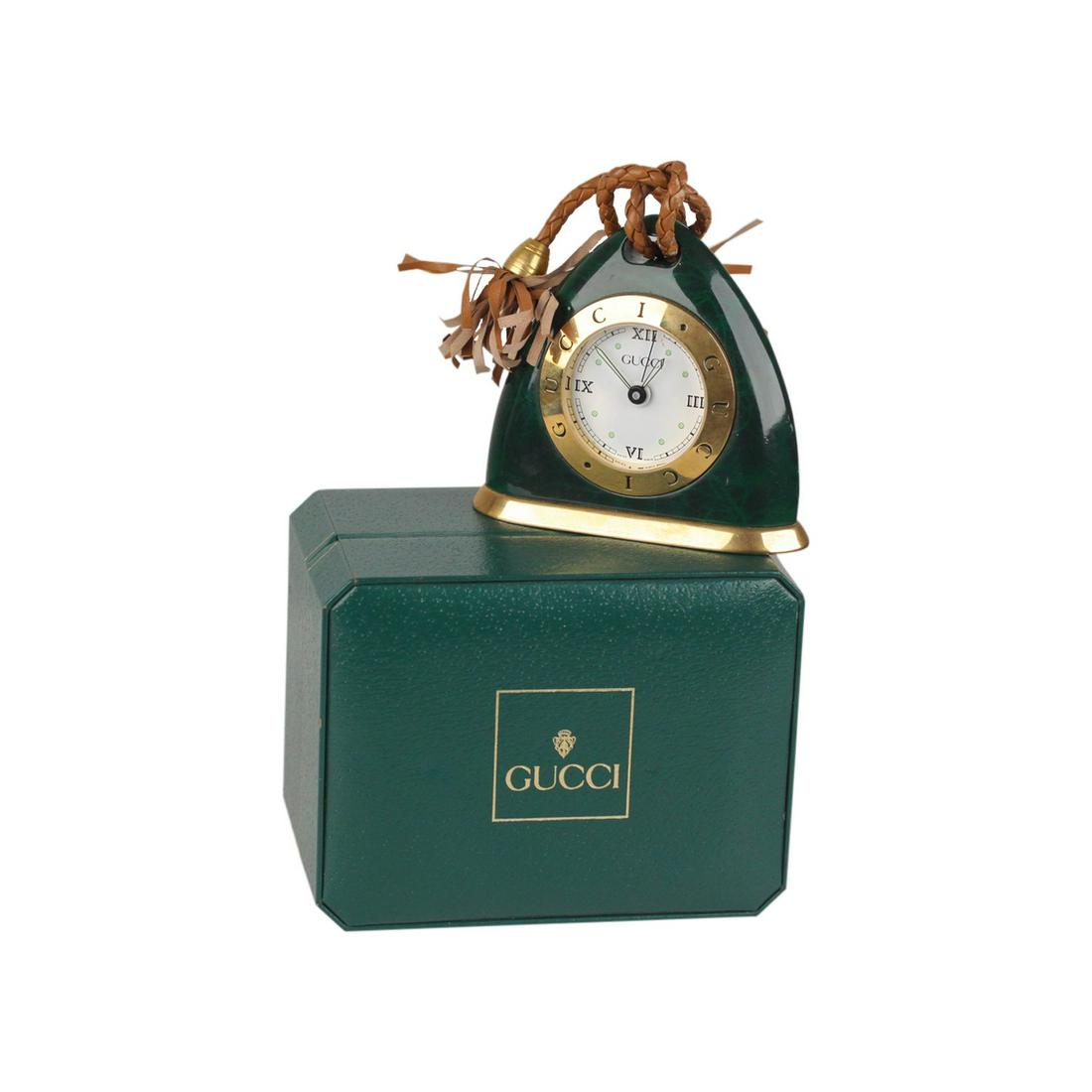 Gucci Vintage Green Stirrup Desk Table Clock Alarm Time: Vintage Gucci gold and green marbled metal stirrup-shaped table clock with alarm from the 80s. Brown braided leather tassels. White dial with GUCCi signature. Quartz movement ( Battery powered - Swiss