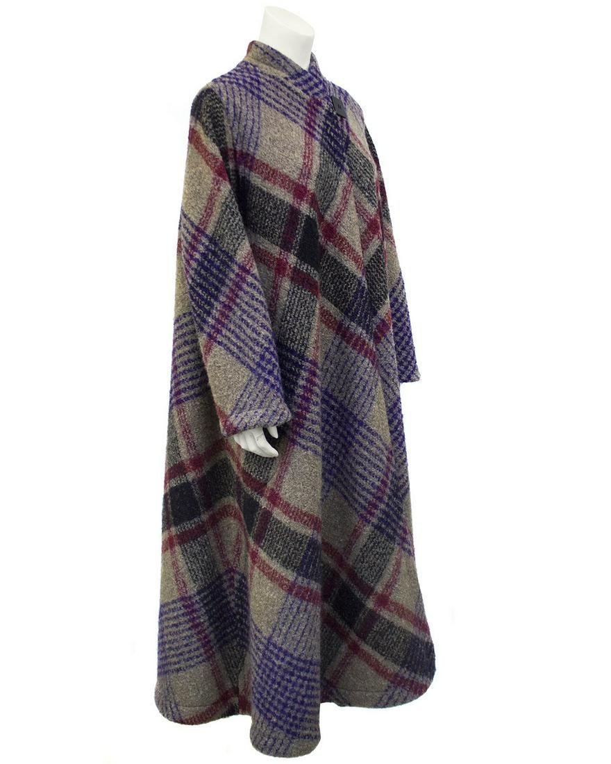 Missoni Grey, Purple and Red Diagonal Tartan Long Wool: 1970s Missoni long wool coat featuring a grey, black, purple and red diagonal tartan. Singular black black square button closure at neck. Unlined. Excellent vintage condition. Fits from US 4-10. Sleev