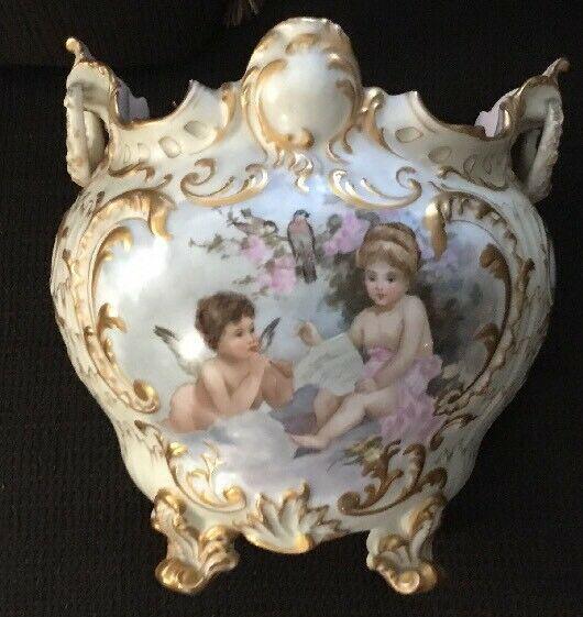 Antique T & V Limoges France Hand Painted Cupids: For sale is a lovely antique T & V Limoges France Hand painted cupids jardiniere. The jardiniere is just gorgeous on the front you have one Cupid reading to the other on the other side the cupids are 