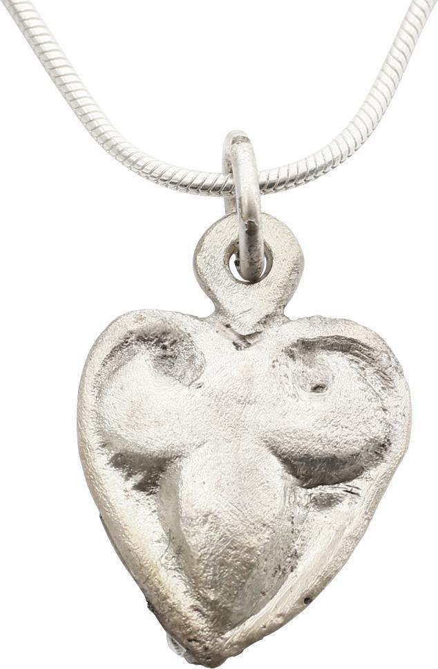 VIKING HEART NECKLACE PENDANT C.900-1000 AD JEWELRY: Early example of the fully evolved form with cusped top. Domed section and high relief curvilinear trefoil infill as favored by Vikings. Petite size, over ½” height plus the loop. The heart stood f