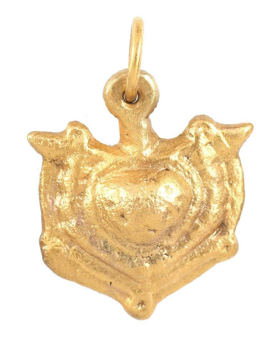 ANCIENT VIKING HEART PENDANT NECKLACE C.1000 AD: A good example in its evolutionary form. High relief with a centered naturalistic heart with beaded surround flanked by reverse curves forming the quartered nubs. Just over 7/8Â” height, made by th