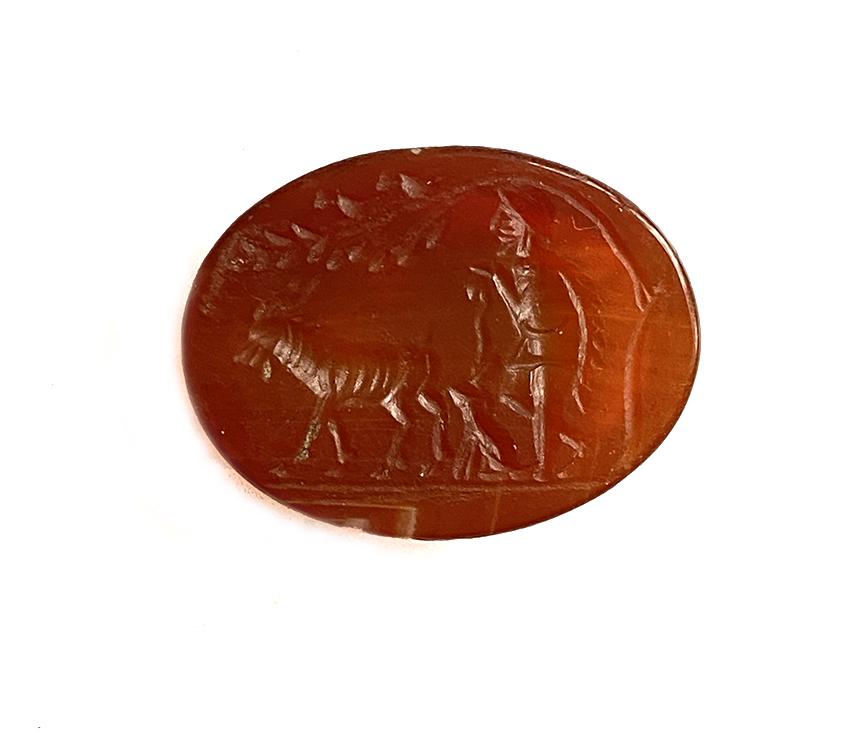 Roman Cornelian Intaglio, Shepherd, Dog and Goat Under: Title: Roman Cornelian Intaglio, Shepherd, Dog and Goat Under a Tree Date/Period: Roman, 1st-2nd Century A.D. Description: Very finely engraved with a walking shepherd holding a long stick, his dog si