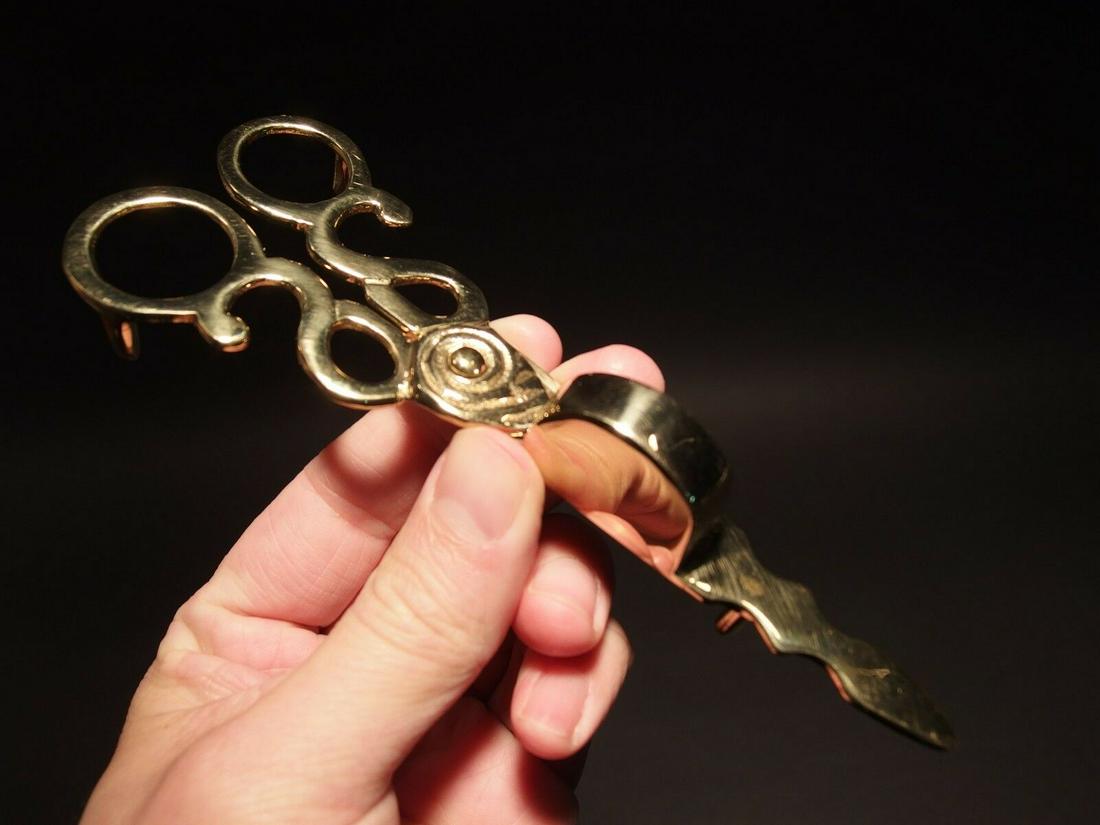 Brass Scissor Candle Snuffer: 6 1/8" Long 2 1/8" Wide Such a great reproduction candle snuffer. Scissor style candle snuffers like this are used like you would guess. Similar to a pair of scissors but to put a candle out without b
