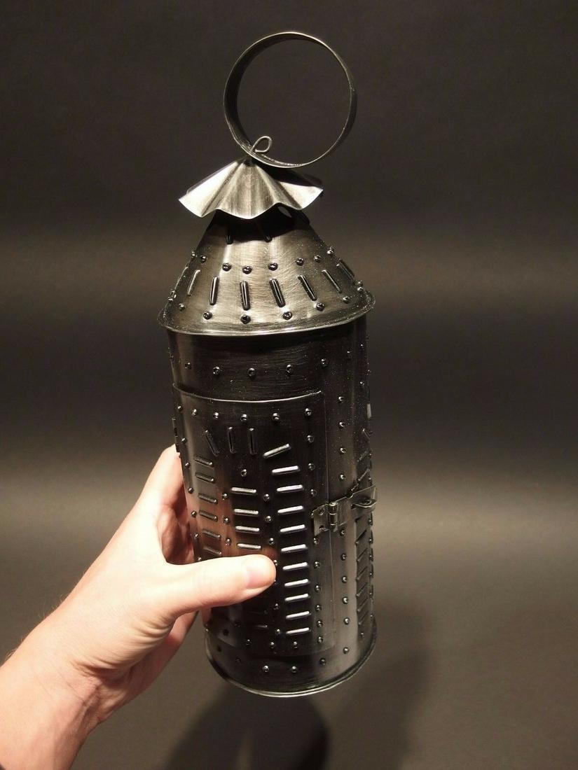 Punched Tin Rolled Iron Candle Lamp: 13 1/4" Tall with hanging ring x 4 1/4" Wide Nice Replica 19th C tin colonial candle lantern with punched tin designs. Made and aged to look just like an original antique. Reserve: $15.00 Shipping: Do