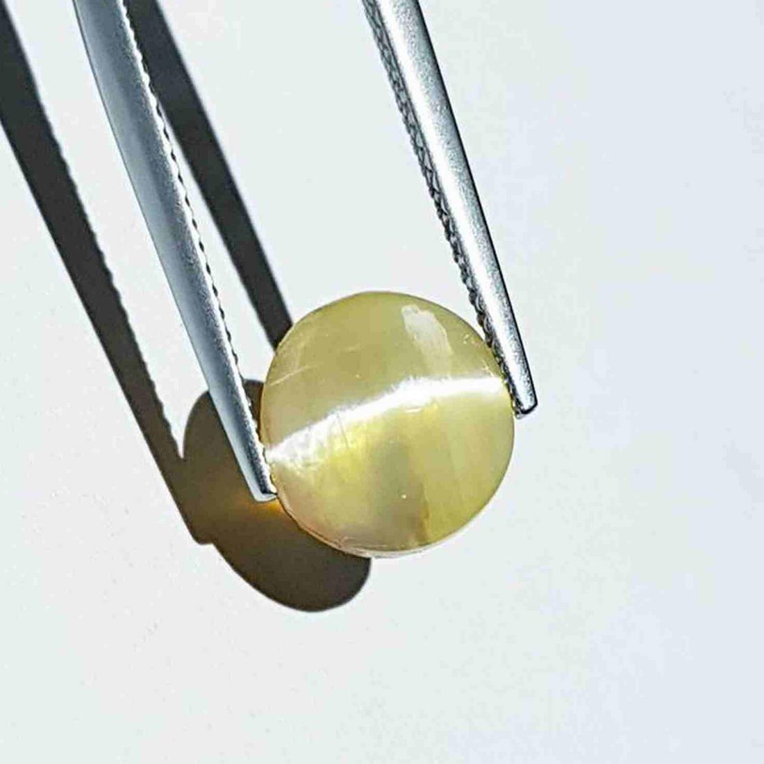 3.45 ct Natural Opal Cat's Eye: No Reserve! Title: 3.45 ct Natural Opal Cat's Eye Color/Clarity: Semi Transparent Type: Loosegemstone Carat Weight: 3.45 Dimensions: 9.80 x 9.50 x 7.30 Additional Information: Round - Africa Shipping: