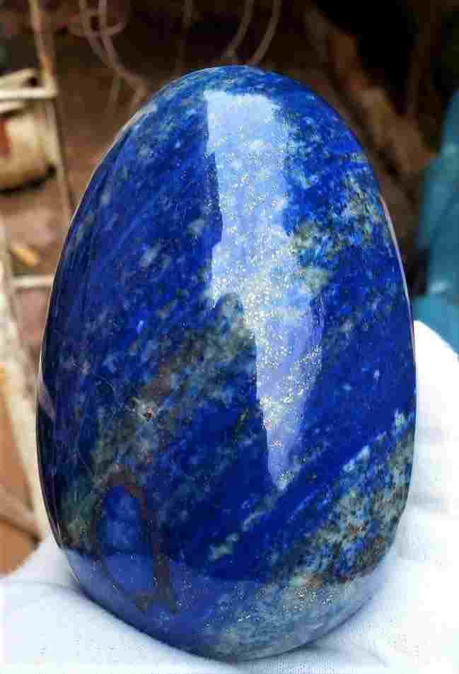 Polished Lapis Lazuli Healing Egg: Title: Polished Lapis Lazuli Healing Egg Stone Color/Clarity: Mineral Carat Weights: 1190 Grams Size/Dimensions: 118X 77 mm Additional Info: Polished Lapis Lazuli Healing Egg Reserve: $150.00 Shipping