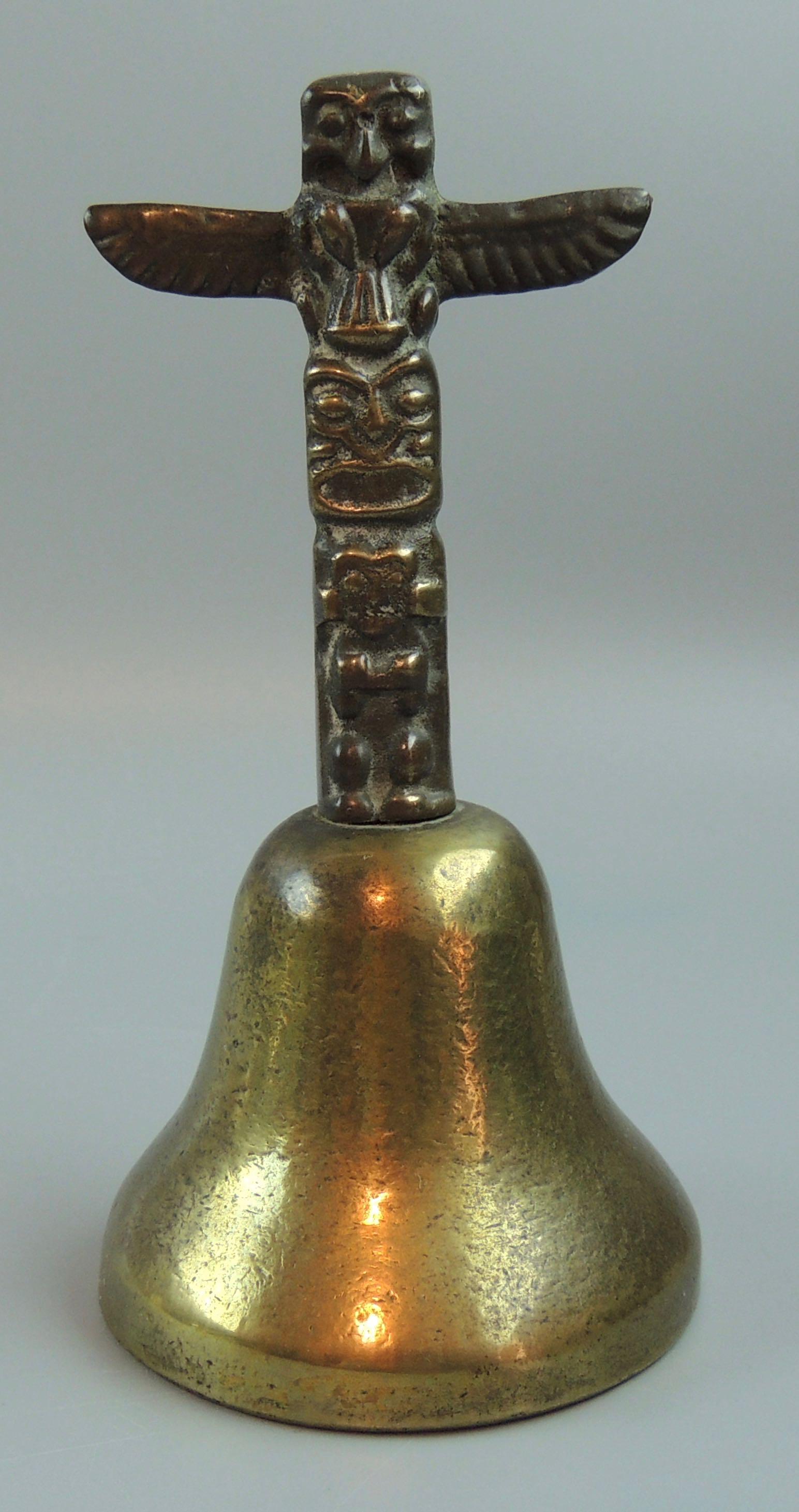 Totem Pole Signed 1972 Brass Bell: Title: Totem Pole Signed 1972 Brass Bell Dimension: 5.25” high x 2.5” widest Additional Information:Figural Totem Pole Signed A.B.A. Vancouver 1972 Solid Brass Bell - Vintage. The bell handle depi