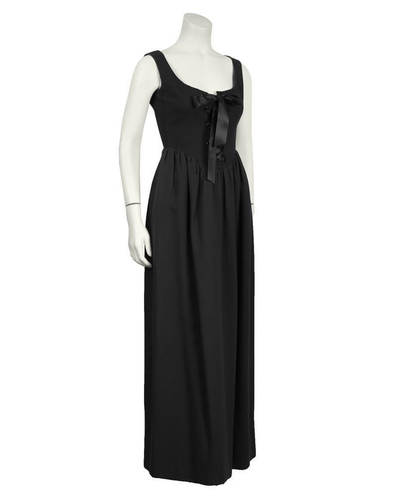 Geoffery Beene Black Cotton Pique Gown: 1960’s Geoffrey Beene black cotton pique gown. Corset like bodice without boning laces up the front with wide black satin ribbon and gathering at the skirt. Heavy weight cotton pique fabric. Lined s