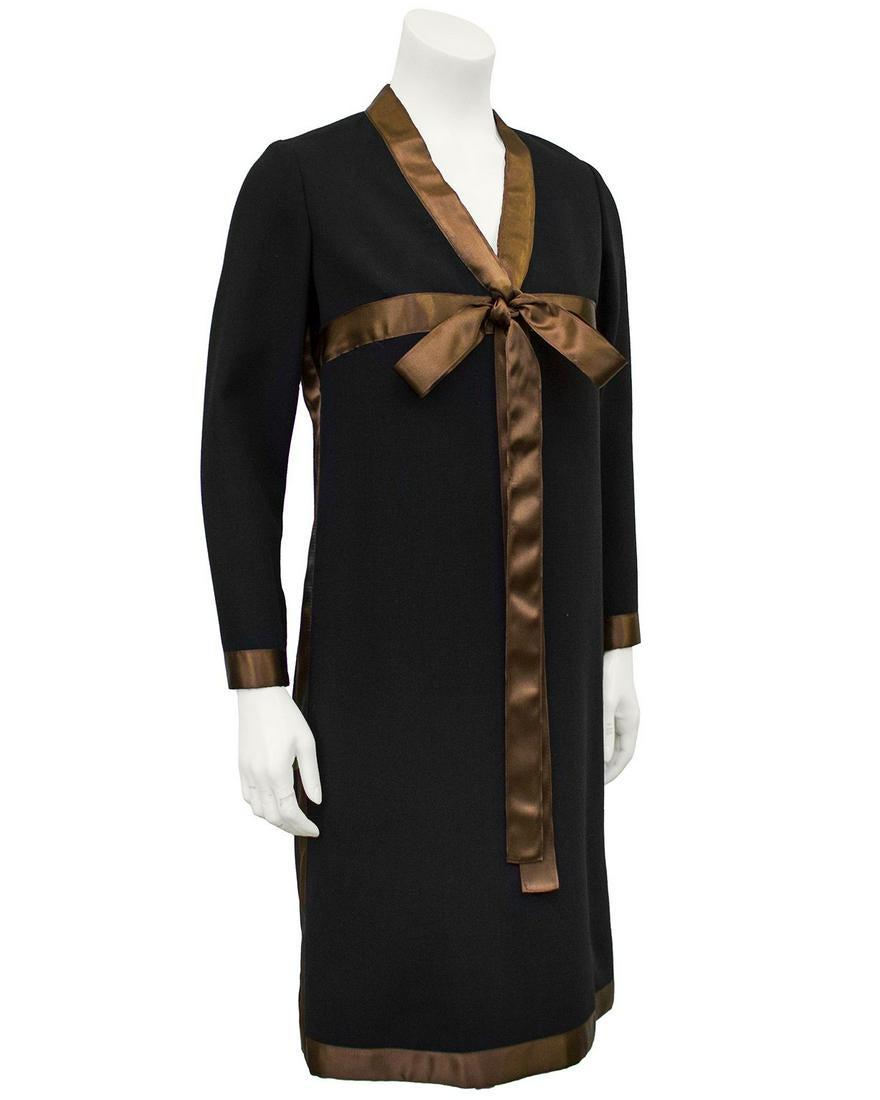 Geoffery Beene Black Dress with Brown Satin Ribbon: Classic style Geoffrey Beene black evening dress with brown satin ribbon detail from the late 1960s. The A-line style long sleeve dress is made of a heavy wool and accented with a sleek brown satin ri