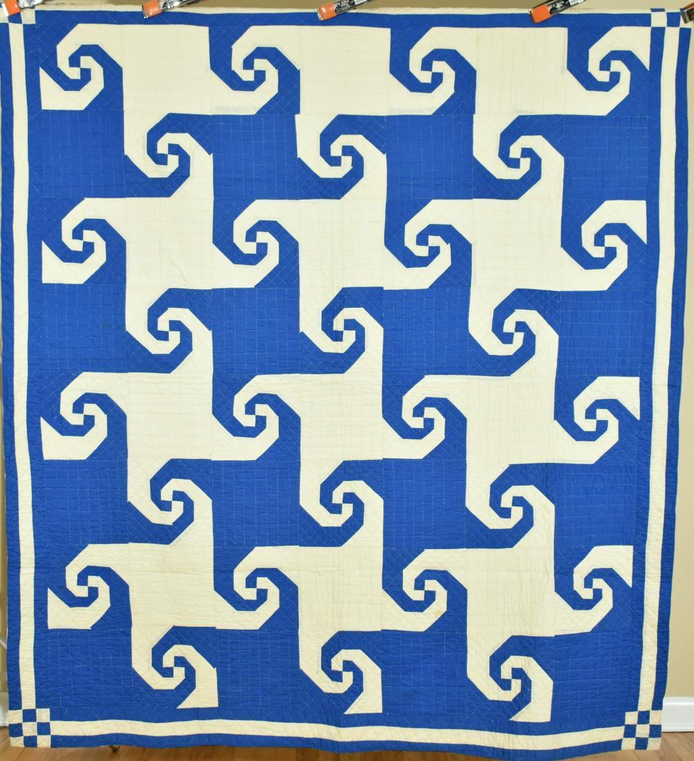 Blue & White Indiana Puzzle Quilt: 30's medium blue and white Indiana puzzle quilt, hand stitched, with Escher-like reverse design. It measures 70" X 78" and is in excellent condition, with the occasional light spot and no wear. There 