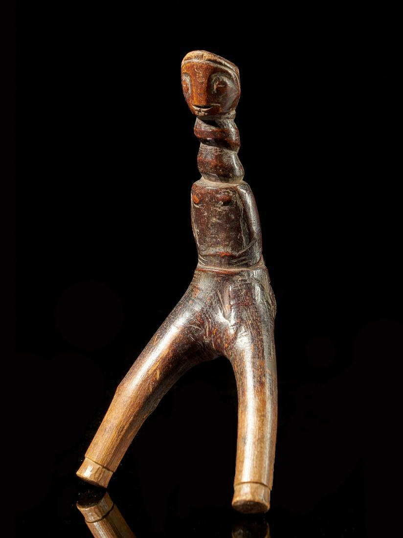 Mossi People,Burkina Faso.Very Old Sling: Title: Mossi People,Burkina Faso.Very Old Sling Additional Info: The Sling has been to look like an armless figure. The tips of the slingshot have a faded and have less shiny appearance than the handl