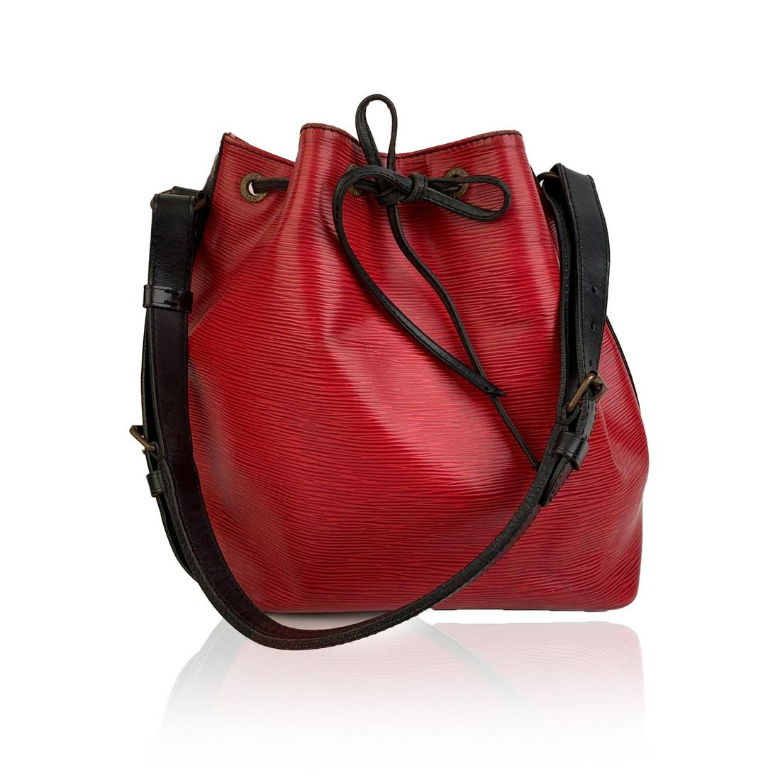 Louis Vuitton Vintage Bicolor Epi Leather Petit Noe Noé: Iconic 'Petit Noé' by LOUIS VUITTON was first created in 1932 to carry champagne bottles. Red Epi leather with smooth black leather trim with drawstring closure and microfibrer lining. 1 side zip poc