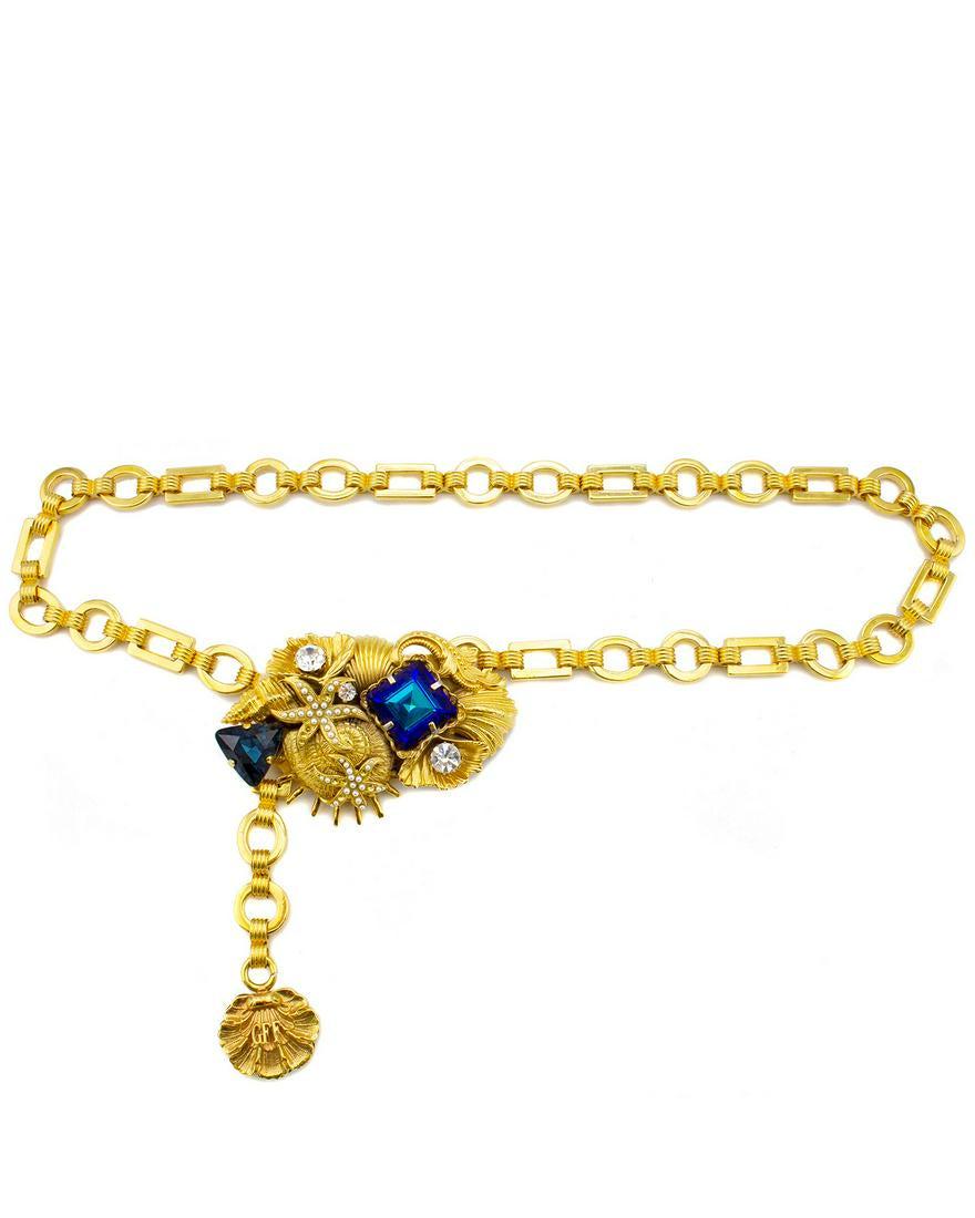 Gianfranco Ferre Gold Chain Belt with Seashell Clasp: 1980's Gianfranco Ferre gold tone, circle and rectangle chain link belt. Large clasp with a hook on back. Large clasp is detailed with a variety of seashells with large blue rhinestones, small silver 