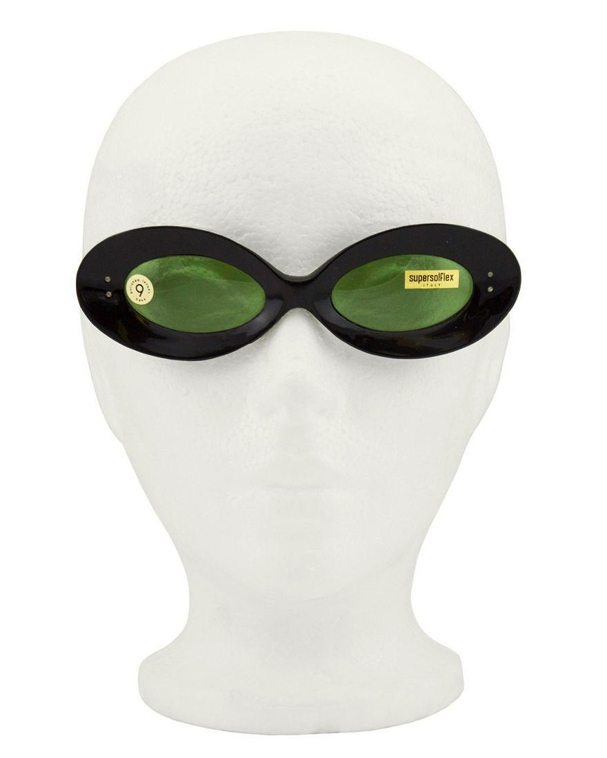 Anonymous: Uber mod 1960s black frame sunglasses with original stickers on the black tinted lenses. Long arms with a slight curve. Never worn. Made in Italy. Frames 6.25" across 1.75" height Arms 4.75" at ears, 