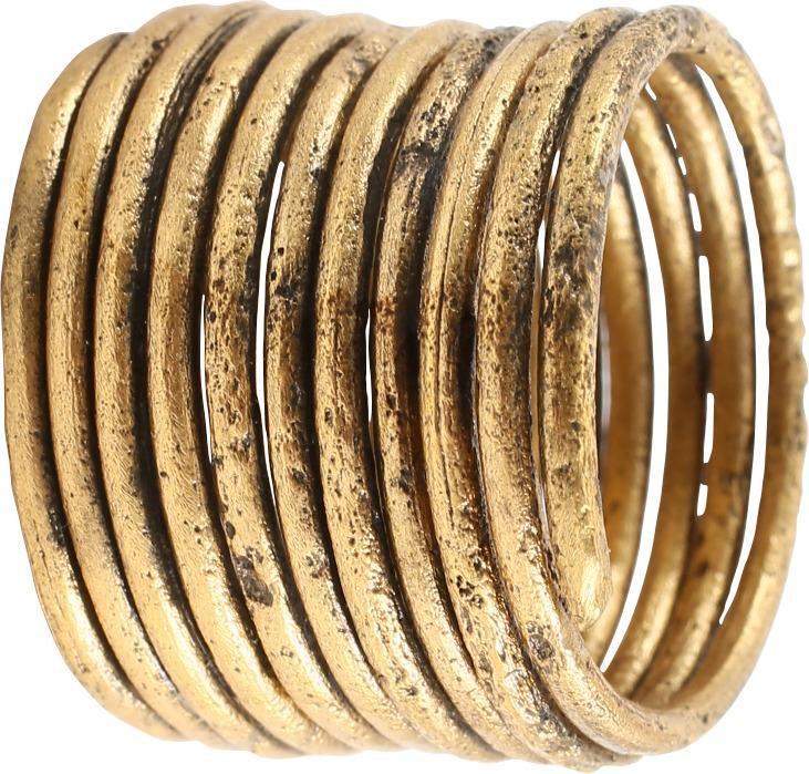 ANCIENT VIKING COIL RING 850-1050 AD JEWELRY: Gold over bronze. Size 9 3/4. Ten turns with tapered terminals. Made by the lost-wax process, coil beads, rings, and other adornment elements were very popular in Viking culture. Due to its age, resiz