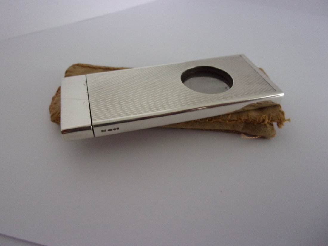 Vintage Cigar Cutter: Title: Vintage Cigar Cutter Description: Sterling silver engine turned cigar cutter by Daniel Jacobs 1984 Sheffield, total weight 18 grams. Original pouch included. Date/Period: 1984 Materials: Sterli