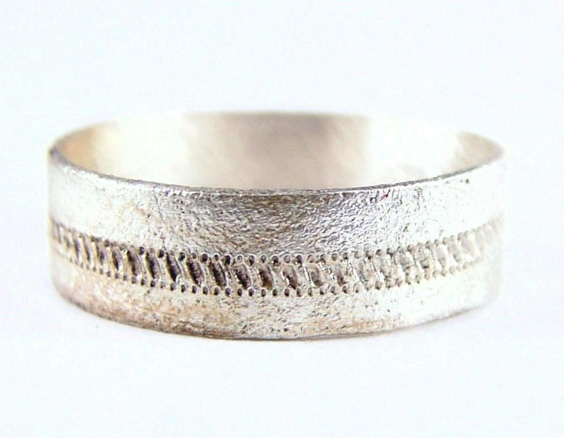 FINE AND RARE VIKING WARRIOR’S BEARD RING: 9th-11th century AD. Flat face ring 4.7mm width with a central incised stipple line or band. Over 1/2” inside diameter. The use of beard rings by Vikings is well documented though very few genuine e