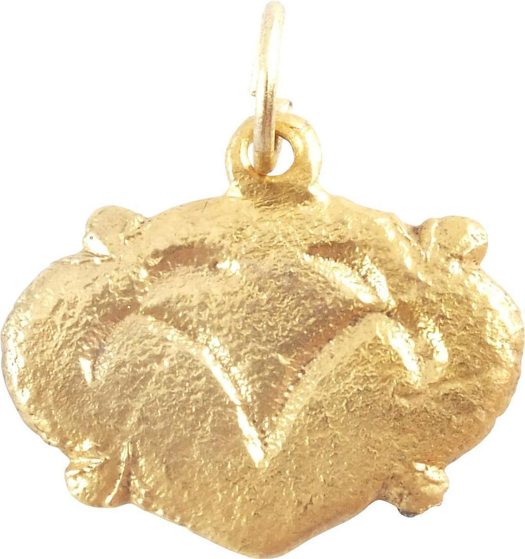 ANCIENT VIKING HEART PENDANT 866-1067 AD JEWELRY: Gilt bronze. 3/4” width. Iconic heart form with a foliate motif. Made by the open face mold technique. Surface textured from burial. Foliate designs were favored by Vikings and incorporated into abo