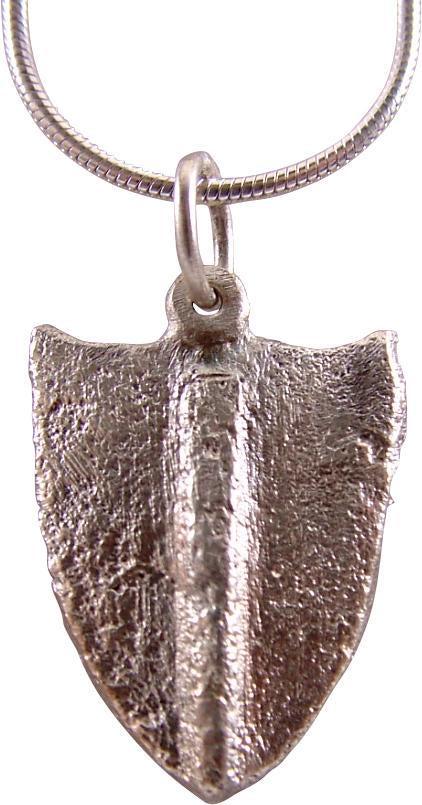 MEDIEVAL EUROPEAN LADY’S NECKLACE PENDANT C.1300-1500: Silvered bronze. Shield shape with a medial bar. 7/8” height plus the suspension loop. The shield form is called an escutcheon represents the arms of a family. In this instance, it is a “charge”