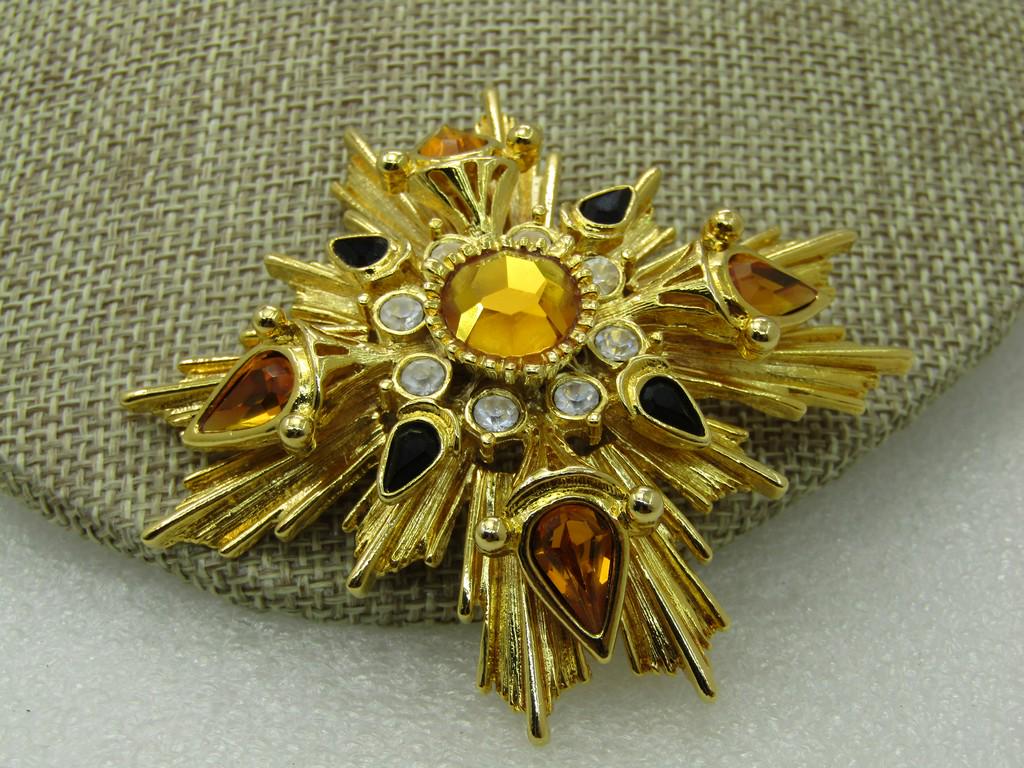 Vintage Joan Rivers Tiered Medieval Themed Brooch with: Vintage Joan Rivers Tiered Medieval Themed Brooch with Rhinestones/Crystals, 2.5", Gold tone with black, golden amber and clear stones. Staggered ray-like accents on the bottom tier with a raised tier