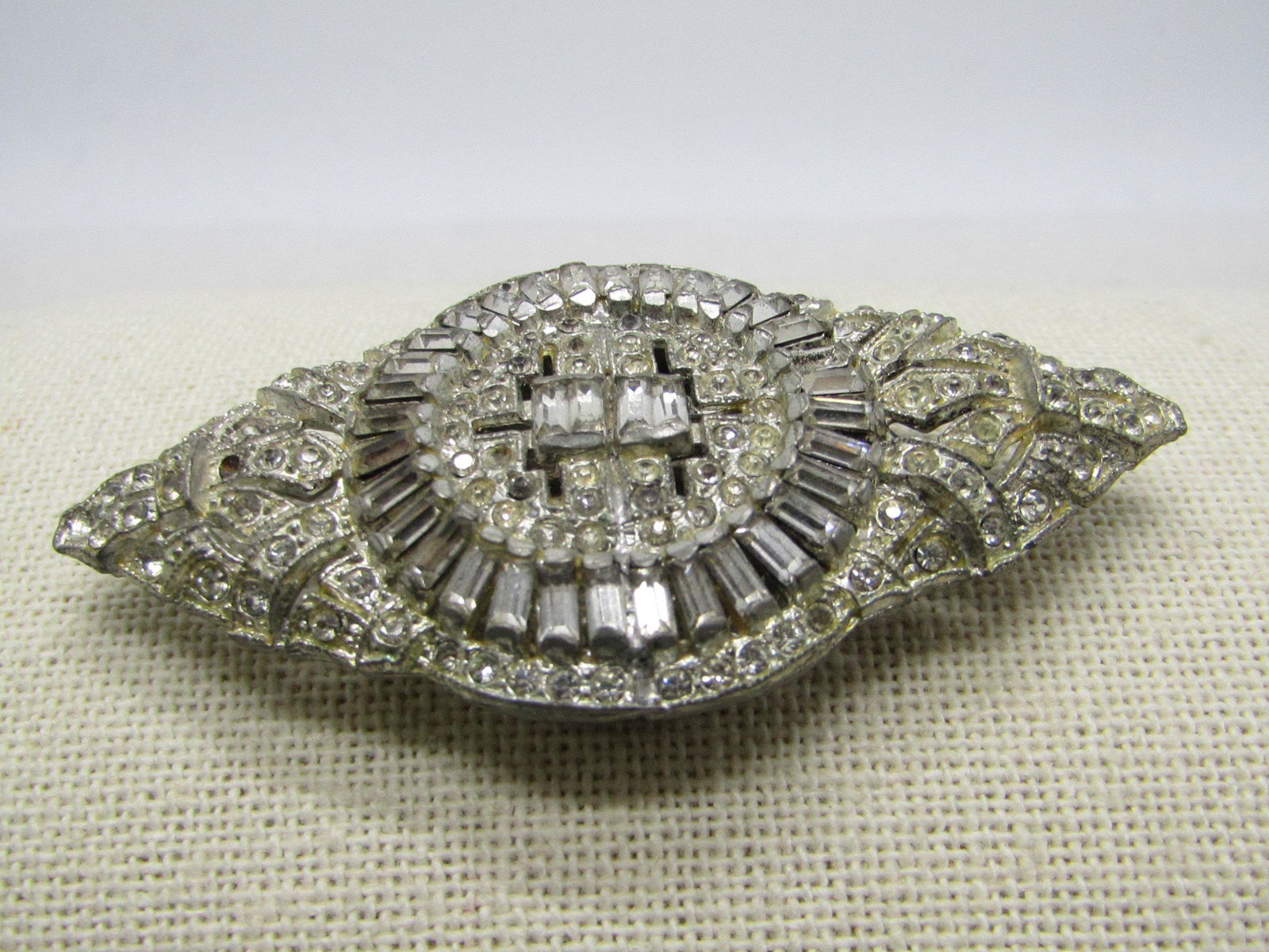 Vintage Art Deco Rhinestone Dress Clip, Pointed, 2.75",: Vintage Art Deco Rhinestone dress clip. It is 2.75" long and 1.5" tall, silver tone cast metal with baguettes and round stones. Pave set - encrusted design. Looks great for it's age. good to very good